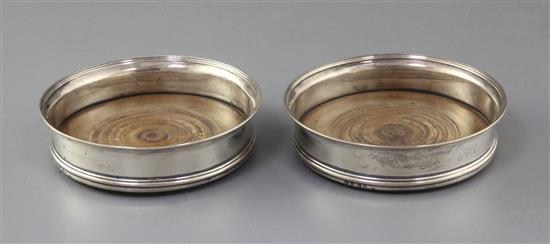 A pair of George III silver wine coasters by Robert Hennell I and David Hennell II, 14.1 cm.